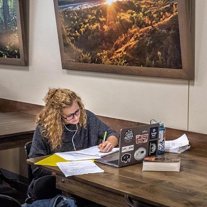 A University of Mary student studying in the lower level of the Crow’s Nest Campus Restaurant.